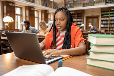 Long-haired african american woman working in the library