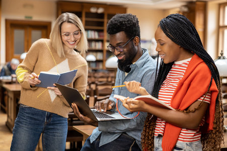 Group of young people in the library looking busy and intersted