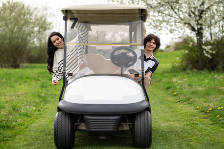 Vehicle in a golf club with young golfers insideの写真素材