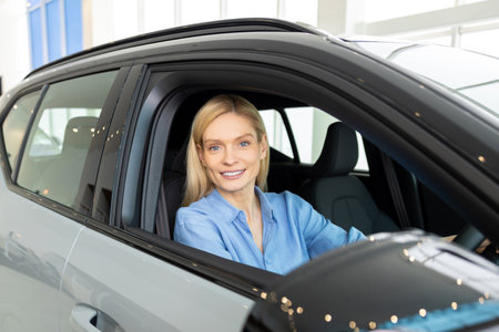 Waist up of a smiling woman sitting in a car