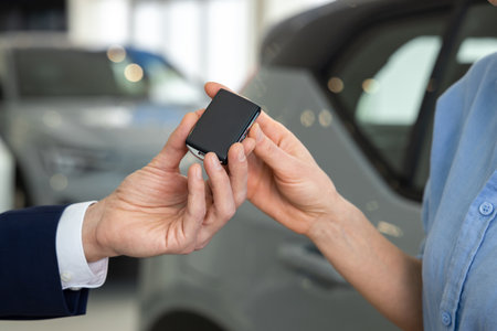 Close up picture of hands passing the car key