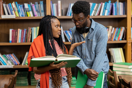 African american students discussing something in the library