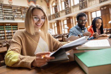 Young people studying in the library and looking involved