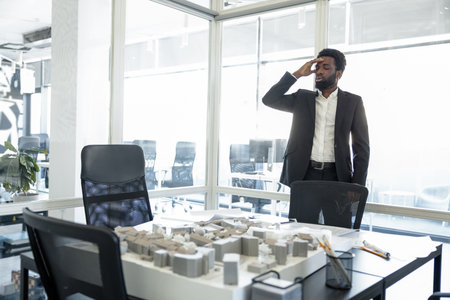 African american businessman in the office looking busy and thoughtful