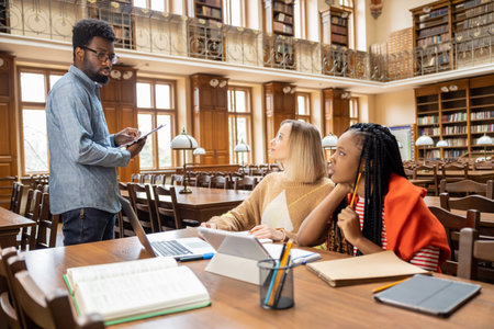 Group of international students working together in the library
