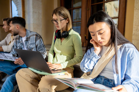 Multiethnic group of students preparing for seminar on stairsの写真素材