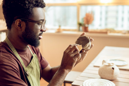 Close up picture of sculptors hands working with a clay mugの写真素材