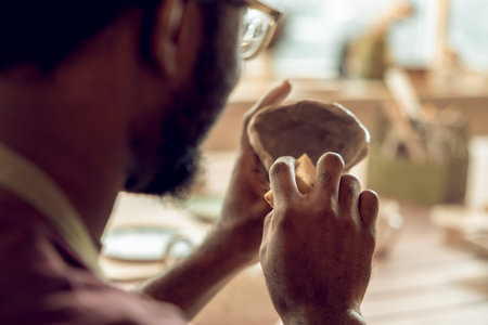 Close up picture of sculptors hands working with a clay mugの写真素材