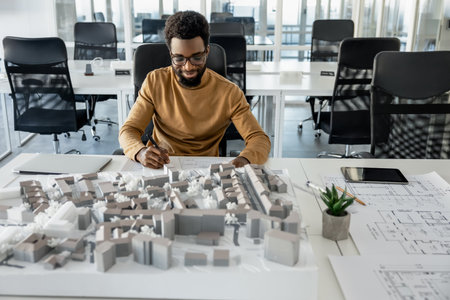 African american architect working in his office and looking involved
