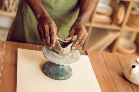 Close up of sculptors hands working with clay