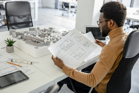 Skillful man architect using technology in his workplace