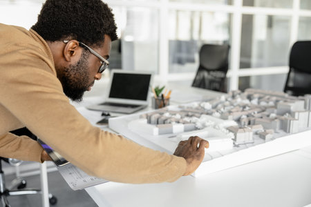 Skillful man architect using technology in his workplaceの写真素材