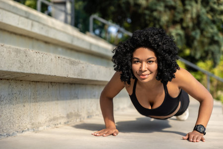 Brunette pretty woman exercising and doing push ups