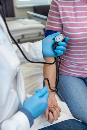 Close up picture of doctors hands measuring blood pressure of a female patient