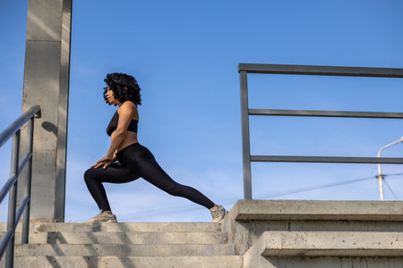 Slim fit black-haired woman stretching in the fresh air