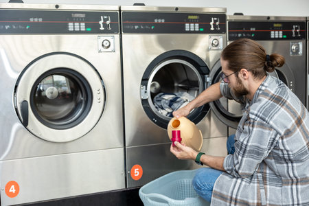 Caucasian adult man managing laundry in public laundry service