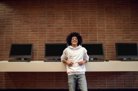 Young student preparing for educational seminar on computer in university library