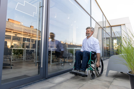 Mature man on a wheelchair looking determined and confidentの写真素材