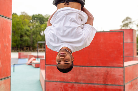 Young male sportsman hanging with his head down