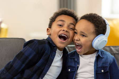 Little boys wearing headphones listening to music singing favorite songの写真素材