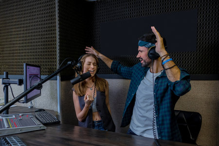 Hipster man and woman playback singers recording trackの写真素材