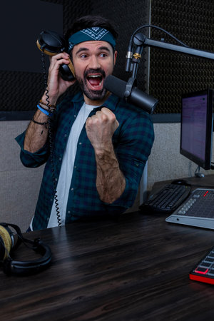 Professional musician with microphone broadcasting online radio live showの写真素材