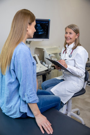 Doctor talking to a pregnant patient after ultrasonography
