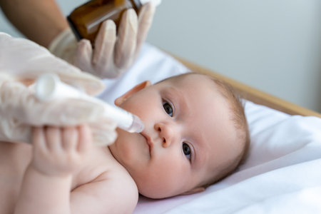 Nurse giving medication to sick kid during a visit to the healthcare clinicの写真素材