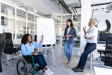 Businesswoman with disability presenting her strategy during business meeting in officeの写真素材
