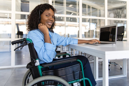 Disabled woman agent in wheelchair with microphone and headset assists clients