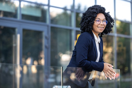Curly-haired business woman on a business center backgroundの写真素材