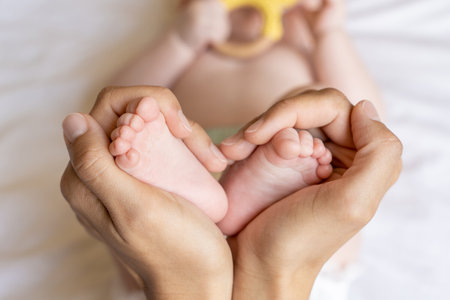 Closeup of babys foot in mother handsの写真素材