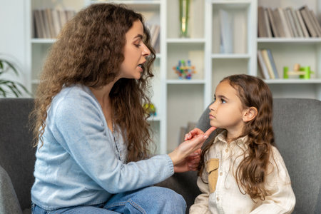 Speech therapist working with a girl and both looking involved
