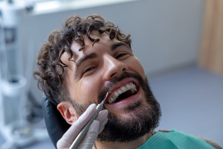 Unknown dentist doing oral examination with advanced dental equipment for patientの写真素材