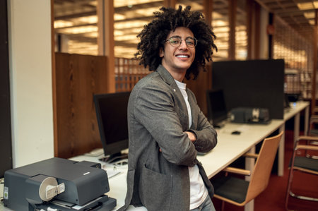Brunette young curly-haired man looking confident and contented