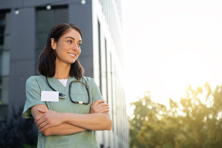 Dark-haired good-looking young female doctor looking contentedの写真素材
