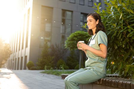 Young female doctor having coffee in the morning after a night shiftの写真素材