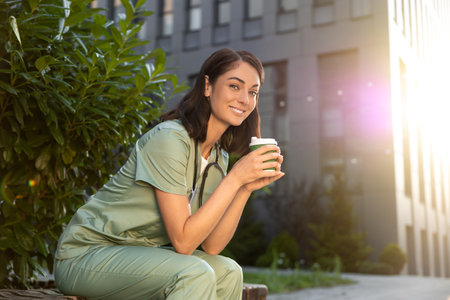 Young female doctor having coffee in the morning after a night shiftの写真素材