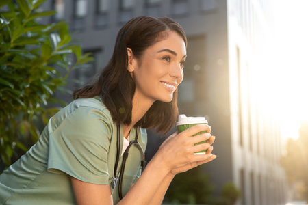 Young female doctor having coffee in the morning after a night shiftの写真素材