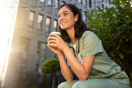 Young female doctor having coffee in the morning after a night shiftの写真素材