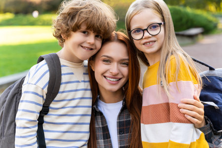 Kids and female teacher outdoors resting promoting social attitudes of friendship and teamworkの写真素材