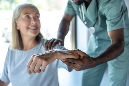 African american doctor working with a female patient in a rehabilitation centerの写真素材