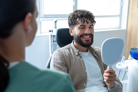 Man patient during whitening teeth procedures in modern dental clinicの写真素材