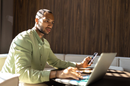 Businessman using laptop computer and smartphone for working onlineの写真素材