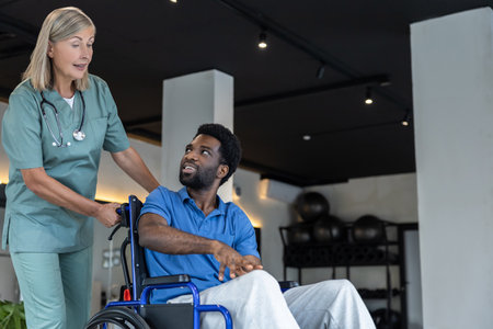 Mature female doctor carrying a wheeling-chair with a male patient