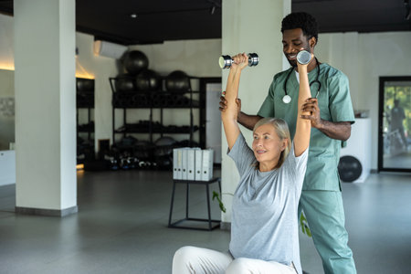 Male physiotherapist working with patient in clinic using physical therapy techniques