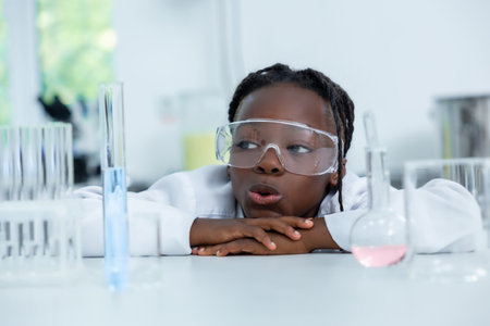 Female chemist in lab testing liquid in flask and tube conducting scientific experiments