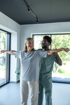 Woman patient in healthcare clinic having physio arms treatment of chiropractorの写真素材