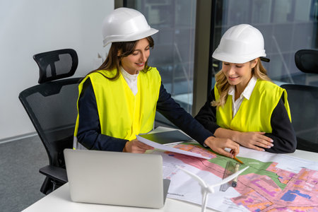 Two female engineers looking involved and excited while working together on the project