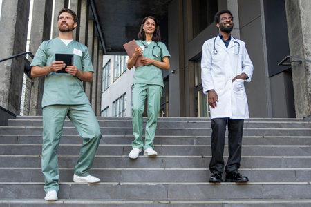 Doctors in lab coats on the steps looking confident